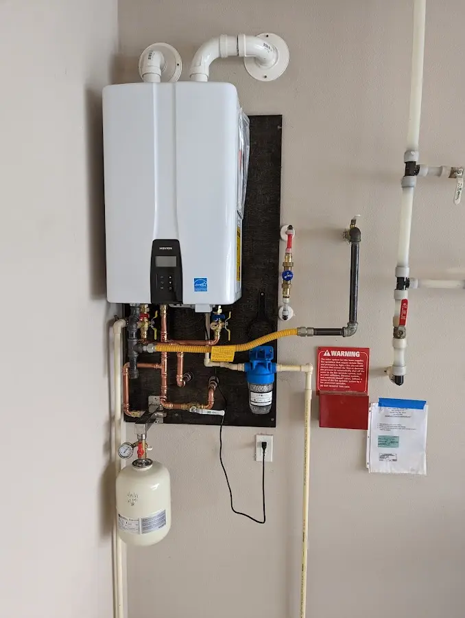 Professional plumber installing copper piping in a Mayfield home